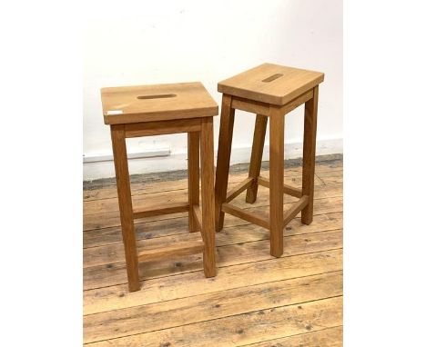 A Pair of light oak bar stools, the tops with pierced carry handles, raised on square splayed supports, H60cm