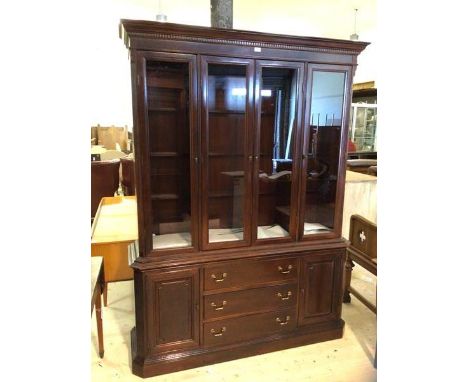 A Georgian style mahogany two-part bookcase cornice with dentil moulding over three sections, one double door flanked by two 