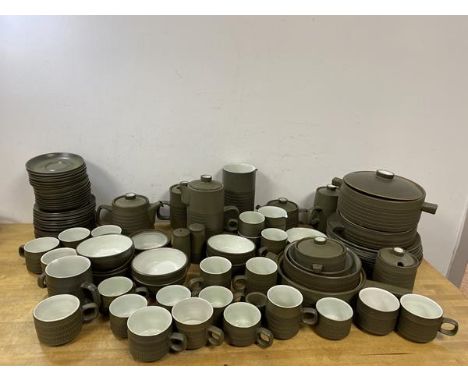 A large quantity of Denby china including eight dinner plates measuring 25cm diameter, coffee cups, mugs, tureens, water jugs