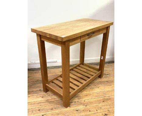 Laura Ashley, A contemporary light oak kitchen serving table, the rectangular top over a frieze drawer, raised on square sect