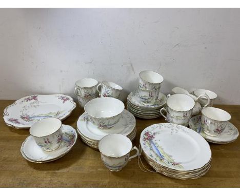 A set of twelve 1920's Hammersley teacups, measure 7cm high, eleven saucers, twelve side plates, a milk jug, a sugar bowl and