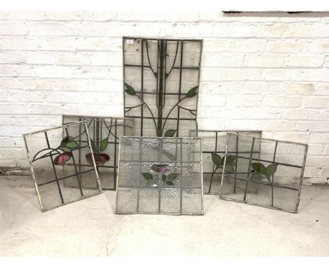 A group of six lead glazed stained glass panels, early 20th century, of floral design, largest 98cm x 47cm