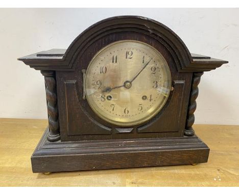 A 1920's oak mantel clock of architectural form, dial with arabic numerals, on bun feet, label to interior British Jerome mov