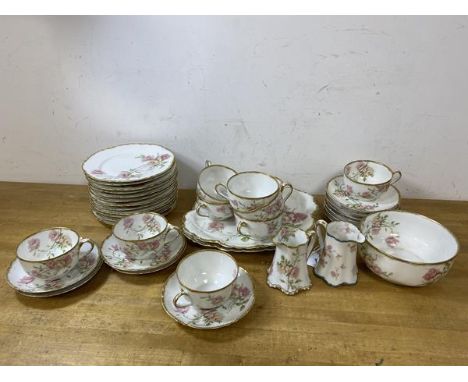 A Haviland Limoges 38 pc tea set including ten teacups, measure 5cm high, eleven saucers, twelve side plates, two cake plates