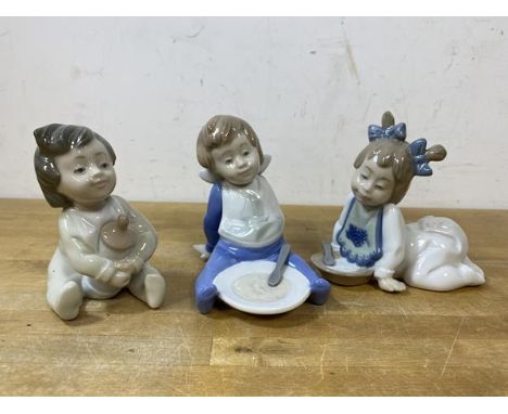 A group of three Nao figures of young children, tallest measures 10cm high