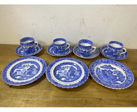 A set of four willow pattern teacups with saucers, and three side plates - measure 18cm diameter