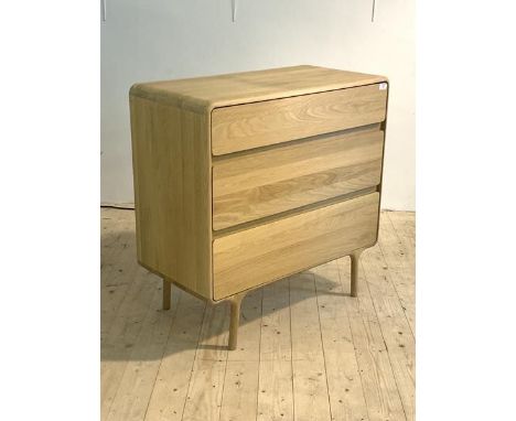 A mid century modern light oak chest, fitted with three drawers, raised on turned supports, H90cm, W90cm, D45cm