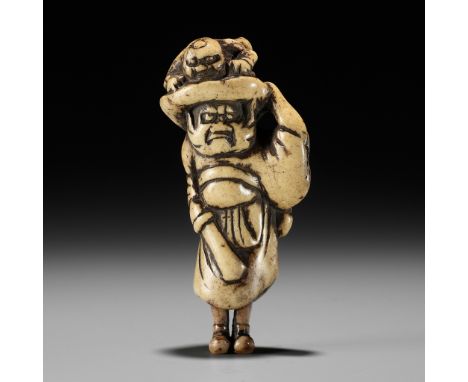 AN ANTLER NETSUKE OF SHOKI AND ONIUnsignedJapan, Kyoto, 18th century, Edo period (1615-1868)The demon queller depicted in typ