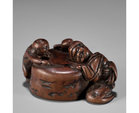 AN AMUSING EDO SCHOOL WOOD NETSUKE OF A SLEEPING MILLSTONE DRESSERUnsignedJapan, Edo (Tokyo), second half of 18th century, Ed
