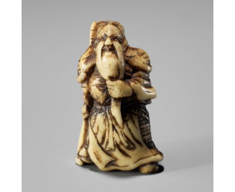 A GOOD ANTLER NETSUKE OF KAN'UUnsignedJapan, 18th century, Edo period (1615-1868)The God of War standing with his dragon-blad