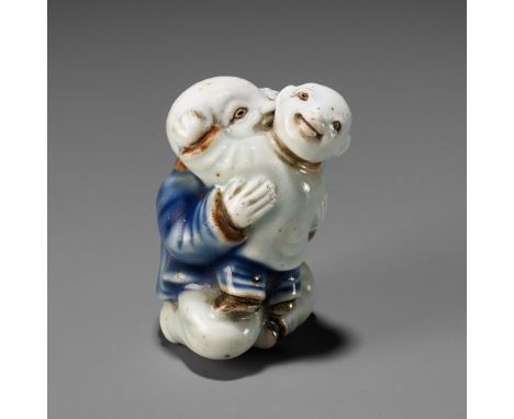 A PLAYFUL HIRADO PORCELAIN NETSUKE OF A CHILD CARRYING AN INFANTUnsignedJapan, 19th century, Edo period (1615-1868)Depicting 