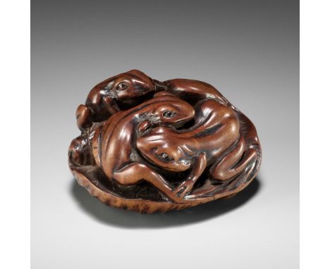 ISSAN: A FINE WOOD NETSUKE OF SUMO WRESTLING FROGS ON A LOTUS LEAFBy Ryusansai Issan, signed Issan 一山Japan, Iwashiro Province