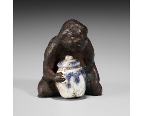 A PAINTED AND GLAZED CERAMIC NETSUKE OF A SOUTH SEA ISLANDER WITH A PORCELAIN JARUnsignedJapan, 19th centuryThe seated South 