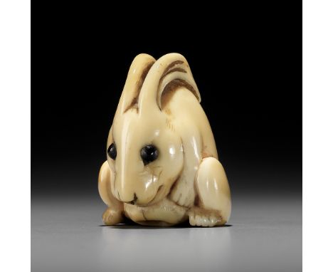 YOSHINAGA: AN IVORY NETSUKE OF A CROUCHING RABBITBy Yoshinaga, signed Yoshinaga 吉長Japan, Kyoto, late 18th to early 19th centu