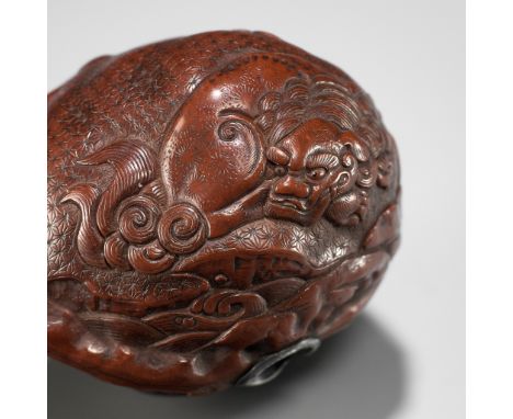 A VERY FINE KURUMI (WALNUT) NETSUKE WITH SHISHI AND PEONYUnsignedJapan, 19th century, Edo period (1615-1868)Of natural shape,