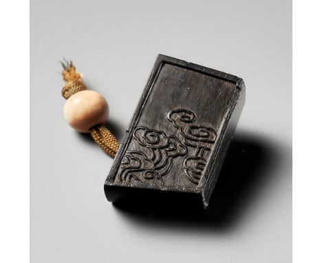 A RARE EBONY WOOD NETSUKE OF AN INK CAKEUnsignedJapan, 18th-19th century, Edo period (1615-1868)Realistically modeled in the 