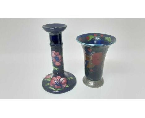 Moorcroft pottery candlestick with floral decoration on blue ground, impressed marks to base, 20.5cm high, together with Moor