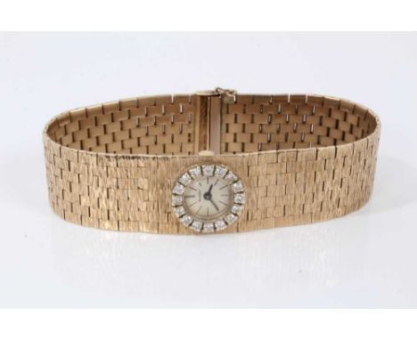 Ladies vintage Bueche- Girod 9ct gold wristwatch with a diamond set bezel on bark effect strapCondition report: Weight 46.3 g