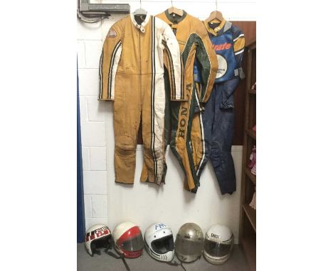 Three vintage motorcycle leathers together with a selection of motorcycle helmets