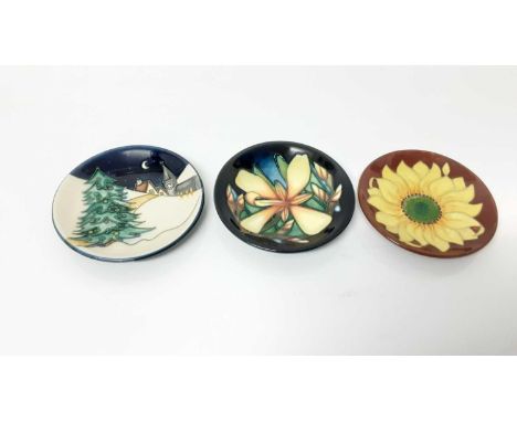 Three Moorcroft pottery pin dishes including Christmas Eve, by Sian Leeper, Panache, dated 2004, and Inca Sunflower, dated 94