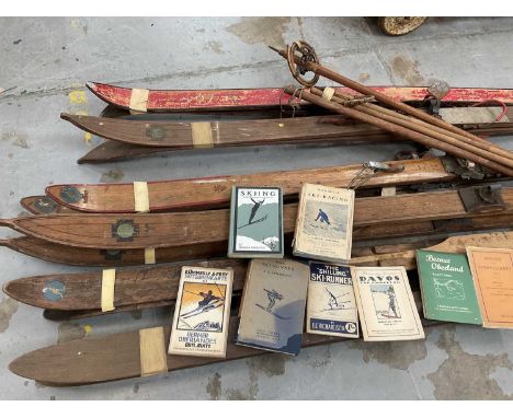 Collection of vintage skis and poles together with a small group of early 20th century skiing books, comprising six sets of s