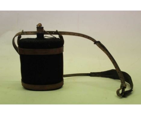 First World War British military cloth covered field water bottle, with brown leather strap dated 1917, together with a colle
