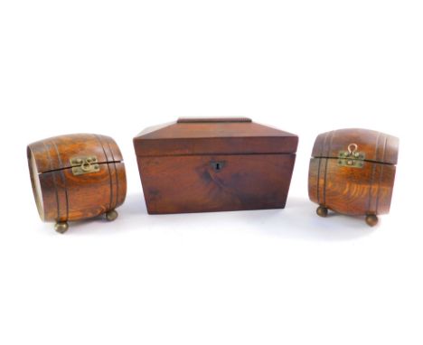 A Victorian flamed mahogany sarcophagus tea caddy, and a pair of Teopani barrel shape oak cigarette boxes. (3) e boxes. (3) 