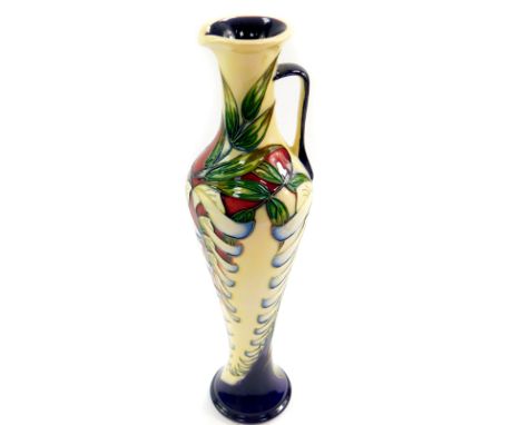 A Moorcroft pottery jug, decorated in the Wisteria pattern by Phillip Gibson, limited edition 54/150, 2005, of elongated bala