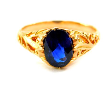 A blue stone ring, possible a spinel, oval cut, set in yellow metal, size K.
