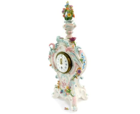 A German late 19thC porcelain cased mantel clock, circular enamel dial bearing Roman and Arabic numerals, thirty hour movemen