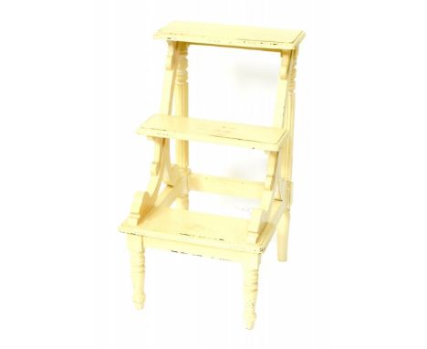A set of Victorian cream painted library steps, of three step form, with scrolling supports, raised on turned legs, 80.5cm hi