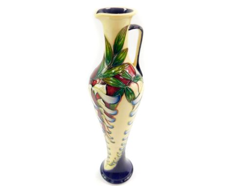 A Moorcroft pottery jug, decorated in the Wsiteria pattern by Phillip Gibson, limited edition 22/150, 2005, of elongated bala