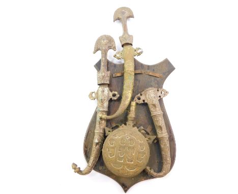 An Ottoman Turkish brass powder flask, a Turkish dagger with a white metal hilt and sheath, further similar sheath and a seco