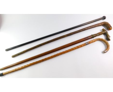 A George V walking cane, silver tipped with silver ferrule, London 1928, 89cm high, a walking stick with horn handle, carved 