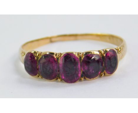 An amethyst five stone ring, set in yellow metal, size K, 1.6g.