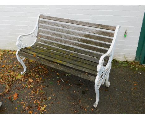 A Victorian style slatted garden bench, with cast iron scrolling supports.