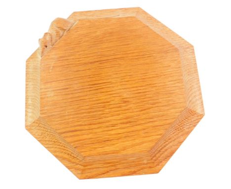 A Robert Thompson Mouseman oak octagonal cheese board, carved with a mouse to the edge, 19cm diameter.