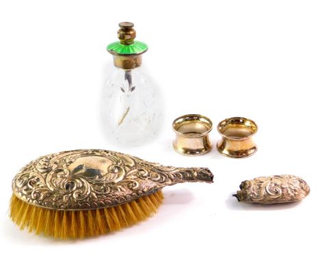 A cut glass and silver atomiser, with green guilloche enamel decoration, two silver napkin rings and a George V silver backed
