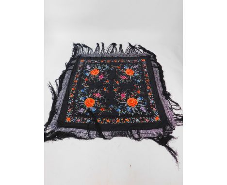 A Chinese vintage black silk shawl, probably early 20thC embroided with flowers, with a black fringe, 116cm square. 