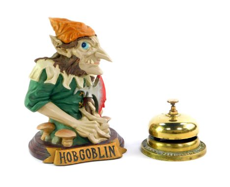 A Bell's Scotch whisky brass bar bell, LVNH Presidential Year 1986, together with a Hobgoblin resin figure, 22cm high. (2)