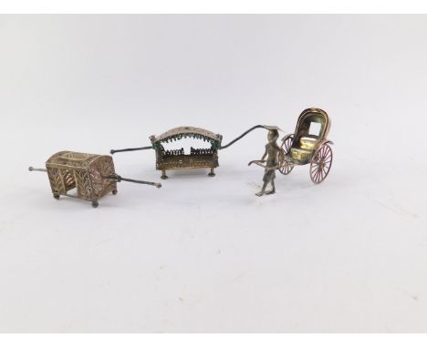 A Chinese silver model of a figure pulling a rickshaw, maker Cumwo, 9cm wide, and two filigree models of sedan carriages, 11c