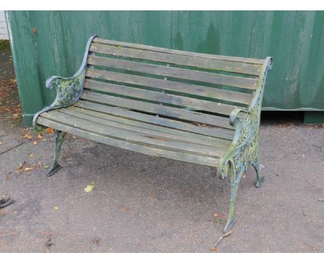 A Victorian style garden bench, with cast iron supports and slatted seat.