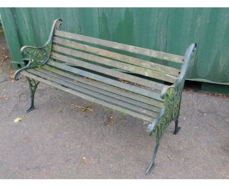 A Victorian style garden bench, with cast iron supports and slatted seat.