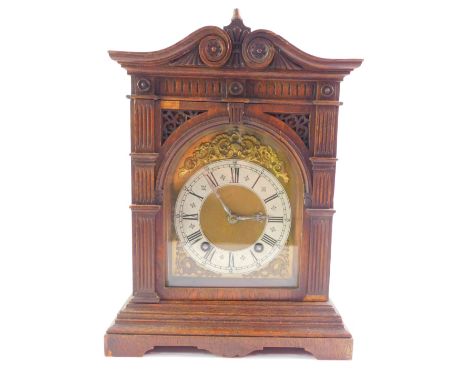 A Lenzkirk oak cased mantel clock, domed brass dial with rococo floral and foliate scroll spandrels, silvered chapter ring be