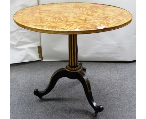 A 19th century North European oval tripod table on a parcel gilt ebonised base, 80cm wide. 