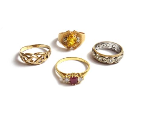 An 18ct gold ring, claw set with a rectangular cut ruby at the centre, between two circular cut diamonds, a gold and colourle