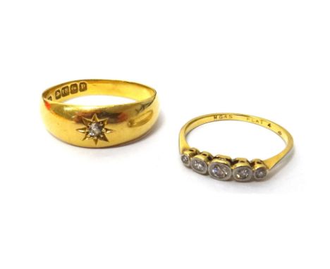 A gold and platinum, diamond set five stone ring, mounted with a row of cushion shaped diamonds, graduating in size to the ce