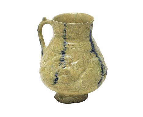 A Nishapur moulded and pierced pottery jug, North East Iran, 12th century, the body moulded with an ibex chased by hunting do