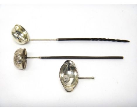 A silver toddy ladle, mounted with a gilt Queen Anne shilling 1709 and with a twisted whalebone handle, another toddy ladle, 