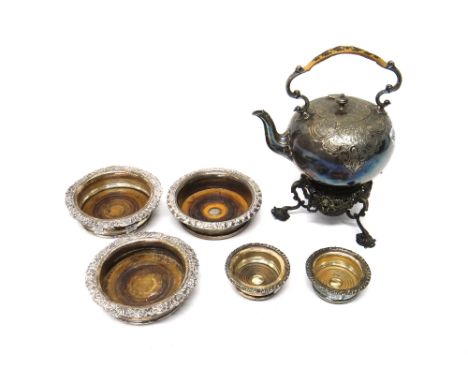 Plated wares, comprising; a tea kettle of early 18th century style, on a tripod stand, a pair of bottle coasters, a single bo
